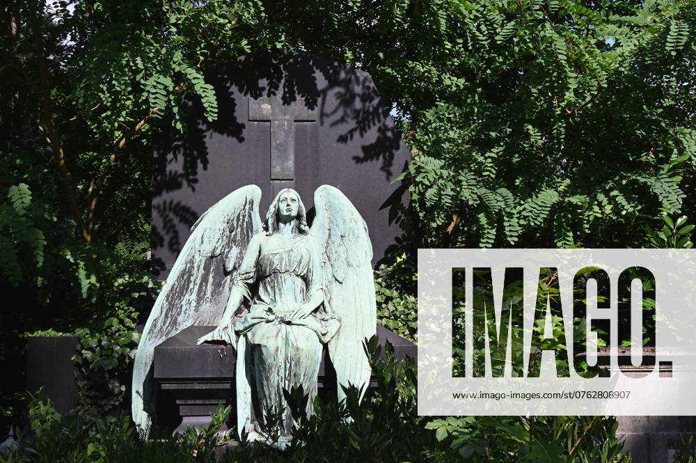 Angel and cross as figures on a grave at the Melaten cemetery for celebrities in Cologne