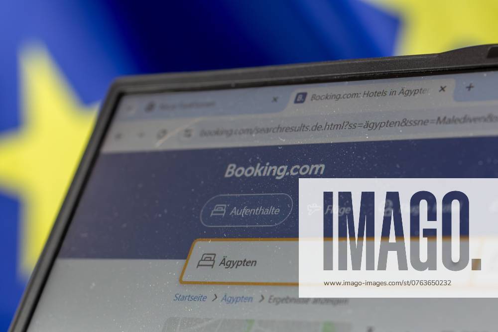 Laptop with Booking com page open in front of the flag of the European Union