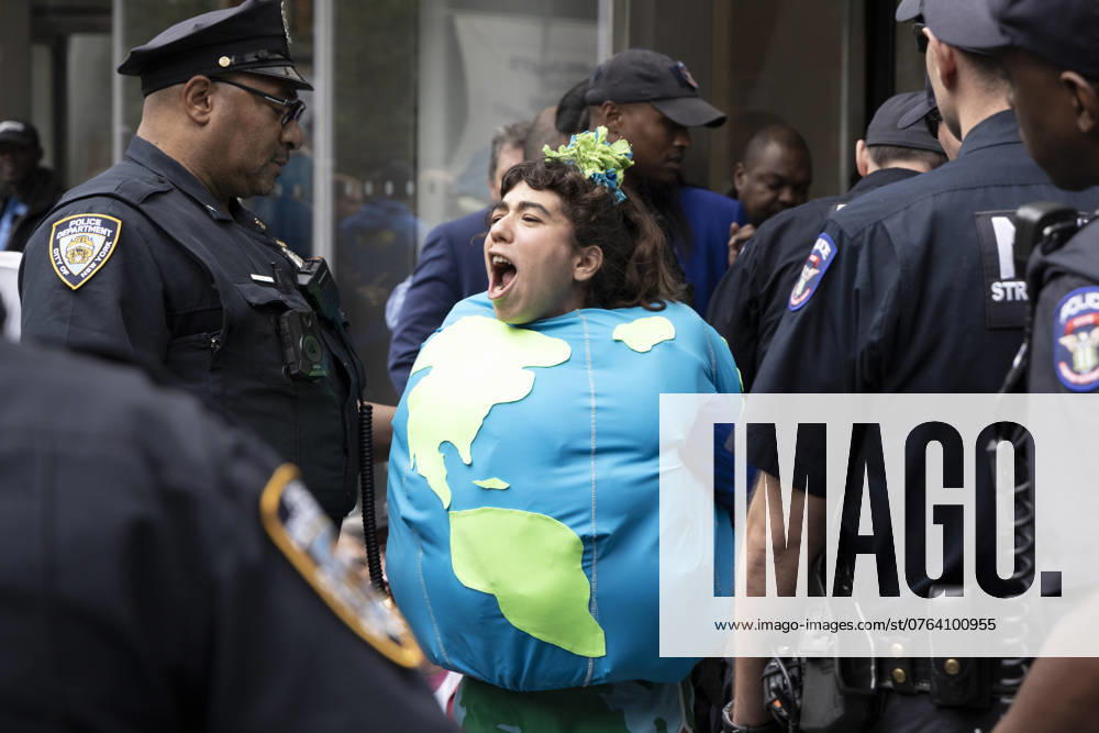 Climate activist HILA THE EARTH is arrested wearing a globe costume at a blockade of Citibank s corporate headquarters in Tribeca. Climate demonstrators led by Gulf South Black, brown and Indigenous environmental advocates request a meeting with Citi s leadership about the harm to their communities from fossil fuel expansion funded by Citibank. After their request is denied, protesters block the entrances to the building in a non-violent act of civil disobedience. Over 100 demonstrators rally on the plaza with a huge NYPD response. Over thirty people are arrested. New York USA - ZUMAr174 20240923_znp_r174_002