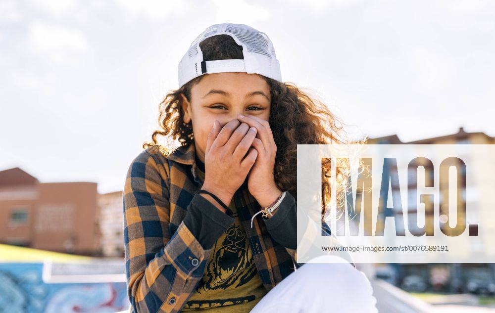 Portrait of laughing girl covering mouth with her hands model released Symbolfoto MGOF02807