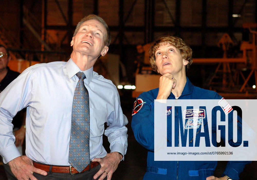 KENNEDY SPACE CENTER, FLA. - Sen. Bill Nelson and STS-114 Mission Commander Eileen Collins watch the newly redesigned External Tank being lifted in the Vehicle Assembly Building to a checkout cell? where the tanks mechanical, electrical and thermal protection systems are inspected. Crew members are at Kennedy to observe tank activities. The tank will also undergo new processes resulting from its redesign, including inspection of the bipod heater and External Tank separation camera. The tank is designated to fly on Shuttle Discovery on Return to Flight mission STS-114. The launch window is May 12 to June 3, 2005.