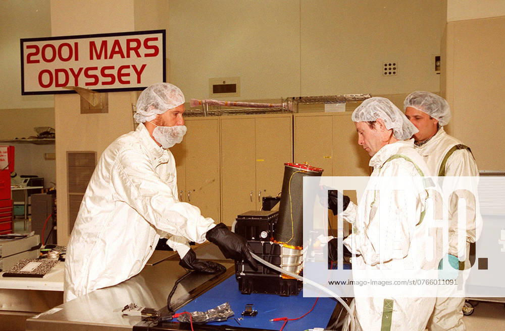 In the Spacecraft Assembly and Encapsulation Facility 2, workers test the Thermal Emission Imaging System (THEMIS) before attaching to the 2001 Mars Odyssey Orbiter. THEMIS will map the mineralogy and morphology of the Martian surface using a high-resolution camera and a thermal infrared imaging spectrometer. The orbiter will carry three science instruments THEMIS, the Gamma Ray Spectrometer (GRS), and the Mars Radiation Environment Experiment (MARIE). The GRS will achieve global mapping of the elemental composition of the surface and determine the abundance of hydrogen in the shallow subsurface. The MARIE will characterize aspects of the near-space radiation environment with regards to the radiation-related risk to human explorers. The Mar