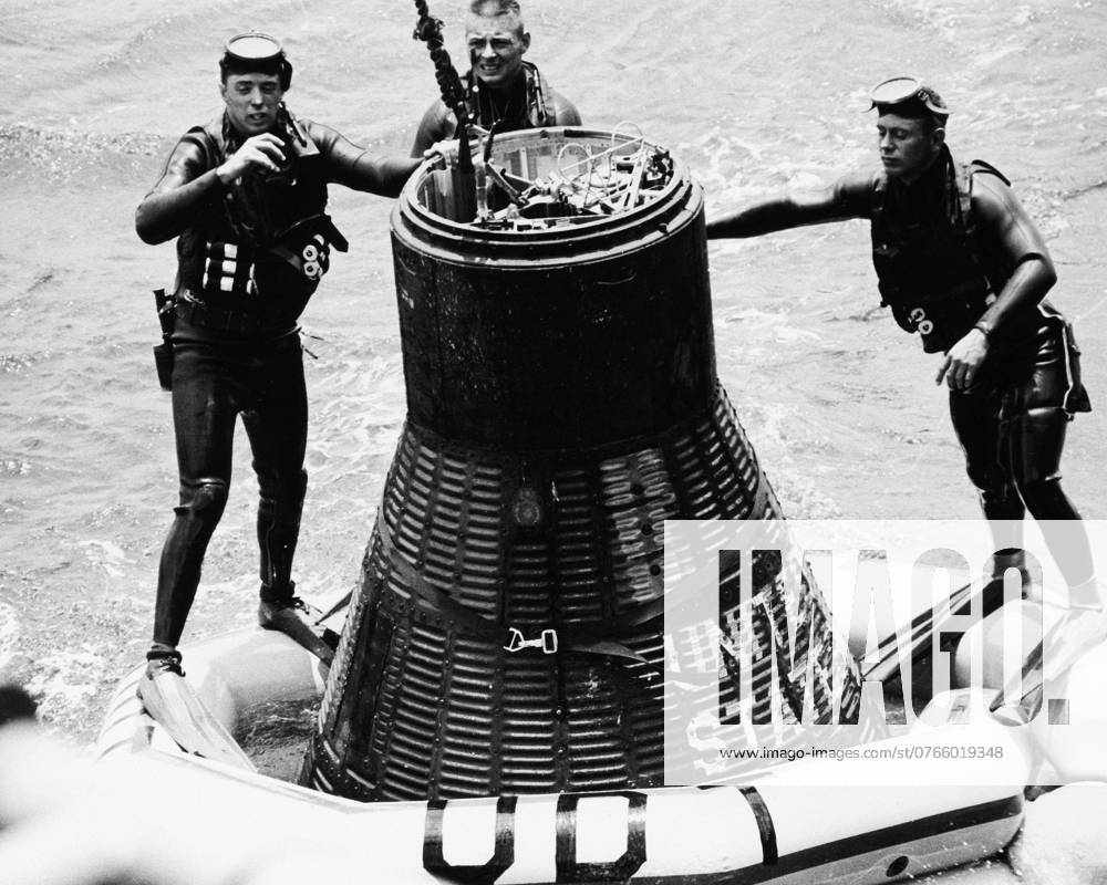USS KEARSARGE. -- Three U.S. Navy frogmen attach a floatation collar to the Faith 7 Mercury spacecraft minutes after the spacecraft splashed down in the Pacific Ocean less than four miles from the aircraft carrier USS Kearsarge, and within sight of those on board.