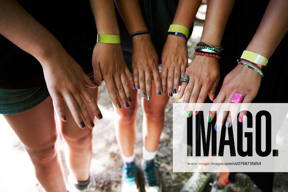 Hands, manicure and woman friends at music festival together, in a circle outdoor closeup from above. Party, concert or show with a group of people at a carnival for performance or entertainment. model released property released
