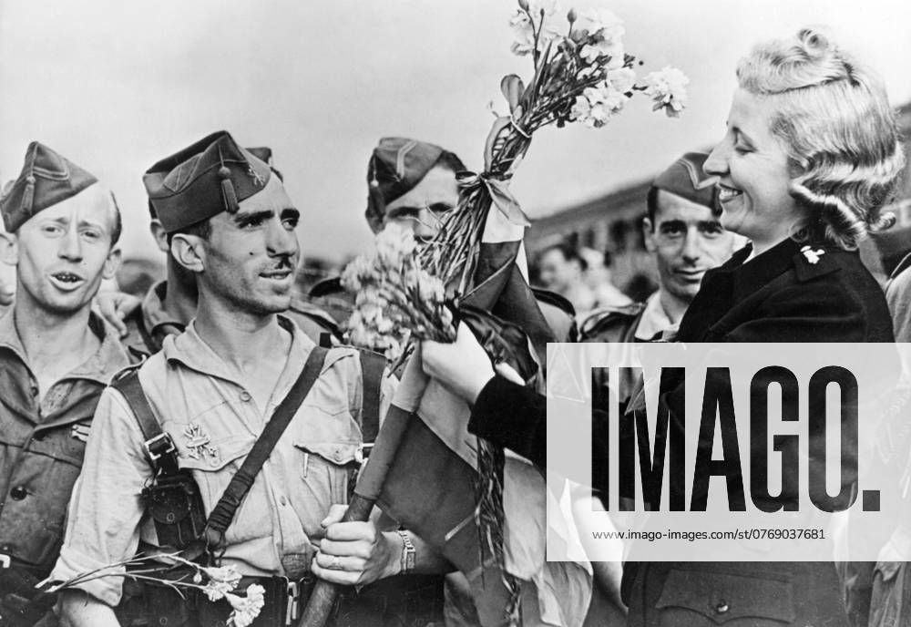 Orig caption DER ITALIENBESUCH DER SOLDATEN FRANCOS The 3,000 Spanish soldiers who came to Italy for a visit visited Milan, where they received a warm welcome U B A Milanese woman decorates the flag of General Francos soldiers Note Spanish Civil War 1936 1939 The rebels the right wing forces led by Franco, supported by Italy and Germany CD16