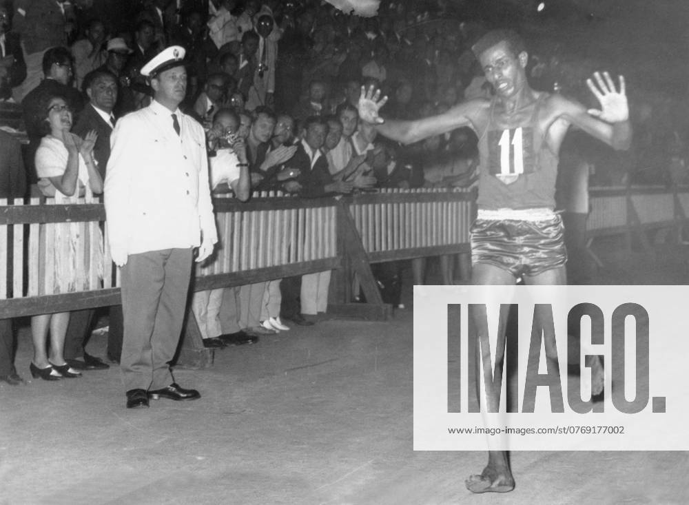 Orig caption After 42 km of marathon the athlete of Ethiopia, Abebe Bikila reached the first the finish line He was tired but happy Photo shows the winner raising the arms for joy Orig caption OLYMPIC FINAL SPRINT Ethiopian Bikila Abebe fi