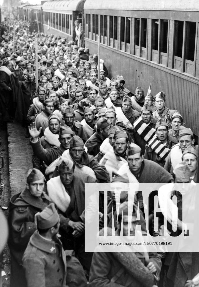 Orig caption REINFORCEMENTS FOR THE ATTACK ON MADRID N P M At the Talavera de la Reina station, large numbers of tra