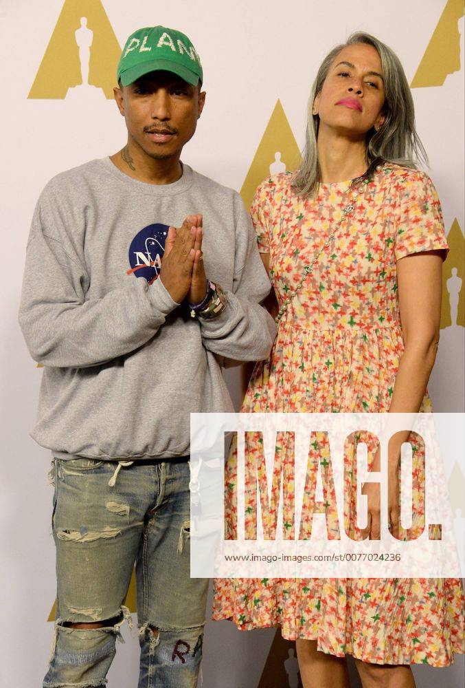 Producer Pharell Williams (L) and Mimi Valdes attend the 89th annual Academy Awards Oscar nominees luncheon at the Beverly Hilton Hotel in Beverly Hills, California on February 6, 2017. LAP20170206146 JIMxRUYMEN