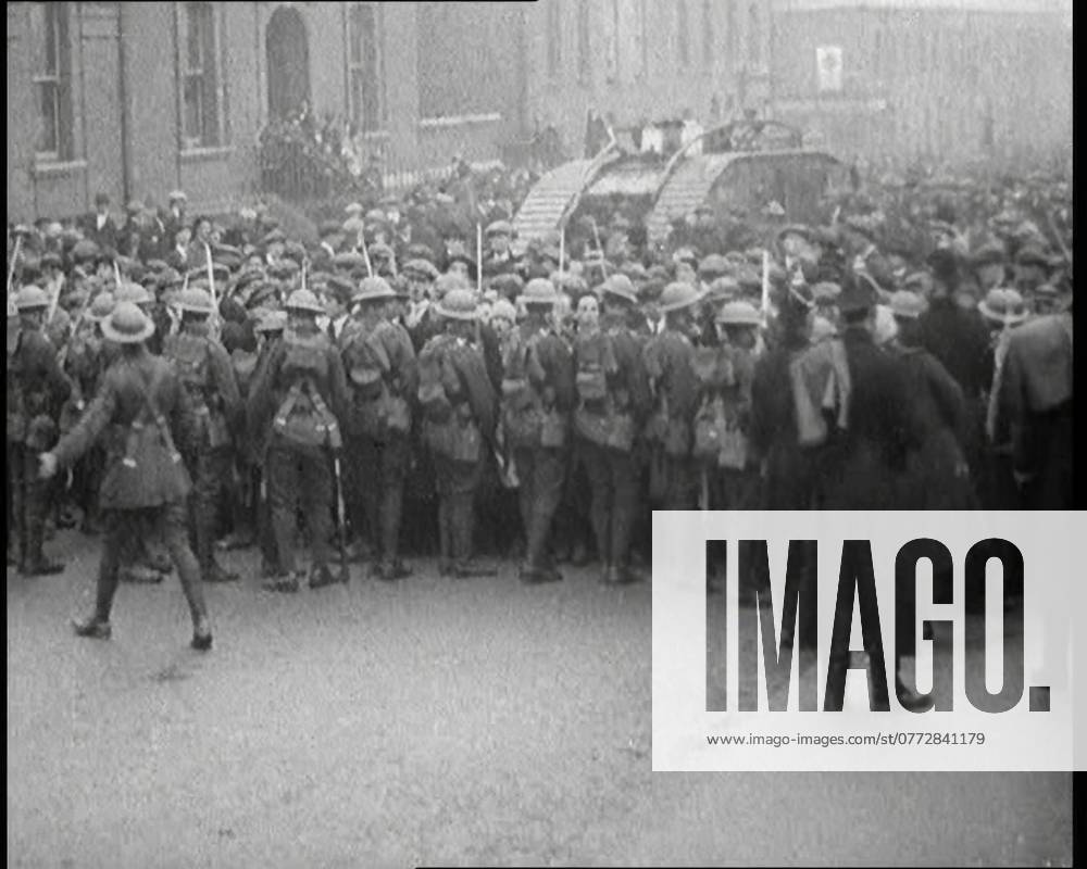 British Soldiers Holding Back Crowds of Demonstrators in Dublin as a Tank Moves Through to Break Them Up, 1920. Outside Dublin s Mountjoy Prison, holding so many of their friends, angry crowds showed the spirit of their city by demonstrations that only heavy armour could break up. But could that spirit really be broken up? . From Time To Remember - The Plunge Into Peace, 1920 (Reel 4); events of 1920 - weddings, women s rights, industrial unrest and problems in Ireland