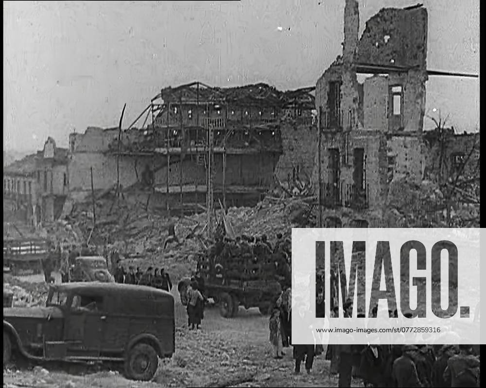 Lorries Carrying Spanish Nationalist Soldiers Loyal To Franco Through Madrid Past the Remains of Destroyed Buildings as Spectators are Looking On, 1939. From Time To Remember - The Reluctant Warriors, 1939 (Reel 1); documentary about events of 1939 - preparations for war and then hostilities break out.
