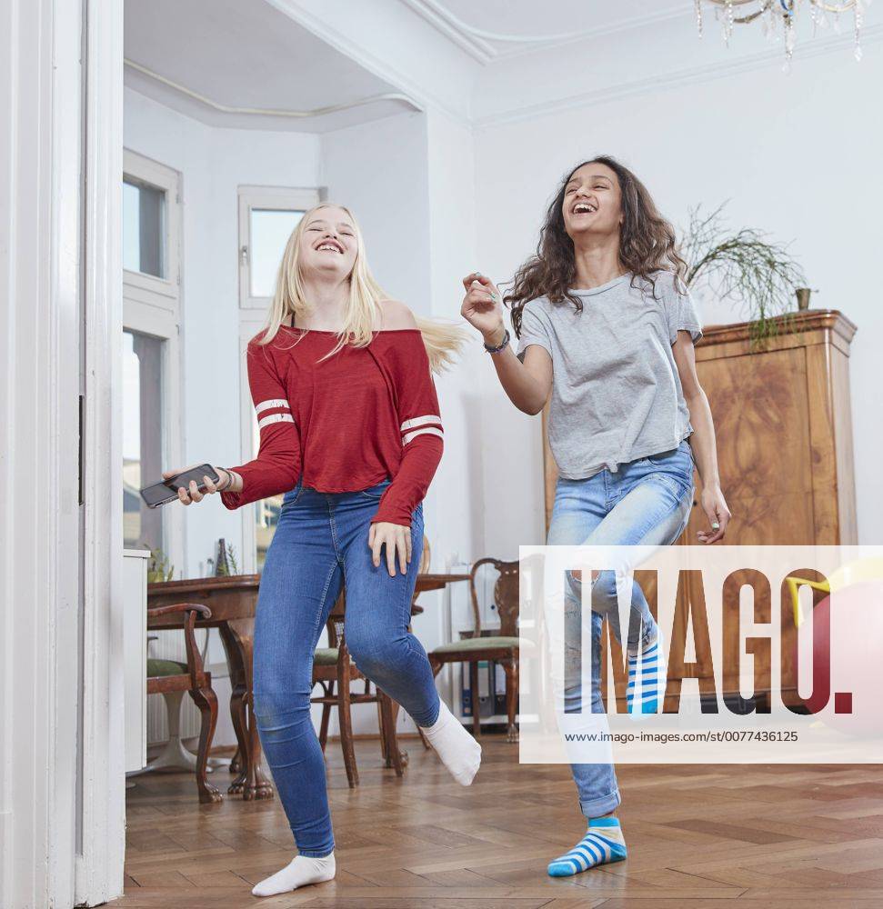 Two girls dancing at home model released Symbolfoto property released RHF01848