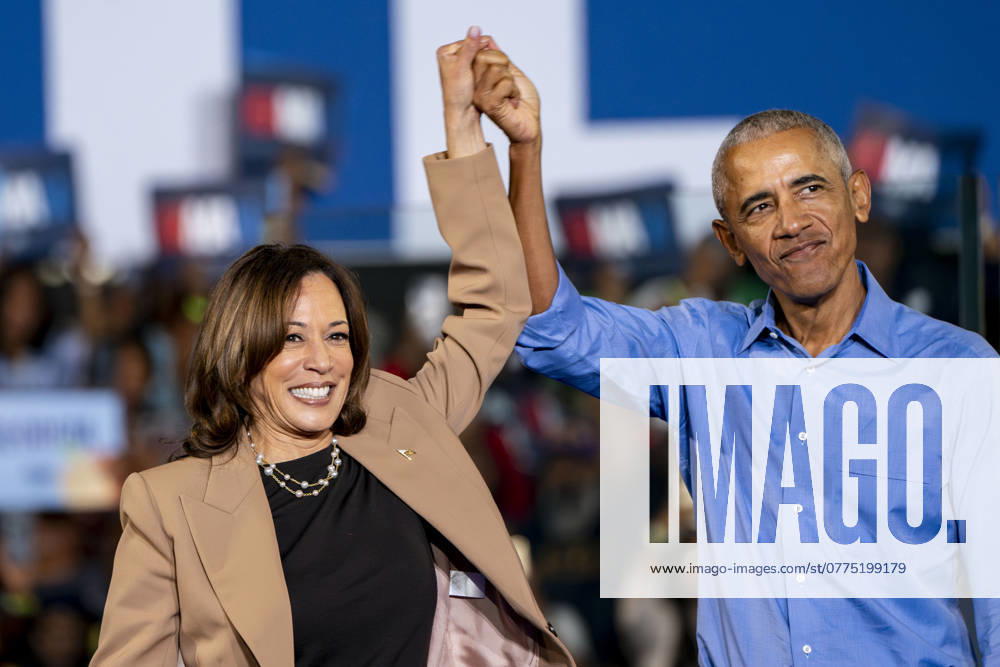 Former president Barack Obama raises the hand of Vice President and Democratic presidential nominee Kamala Harris during a campaign rally at the James R Hallford Stadium in Clarkston, Georgia on Thursday, October 24, 2024. CLA20241024366 BONNIExCASH