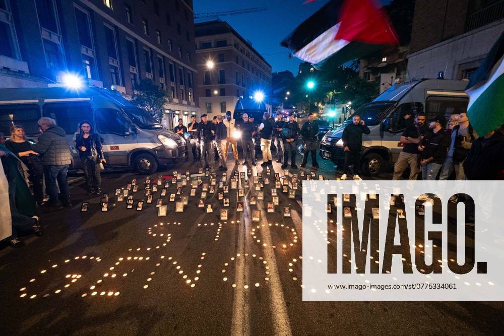 Citizens and activists gather to take part in a rally to support Palestine in front of the US embassy. Police block the access. The activists put the photos of some of the Palestinian child victims on the ground in front of police blockade. Rome Italy - ZUMAg256 20241025_znp_g256_062