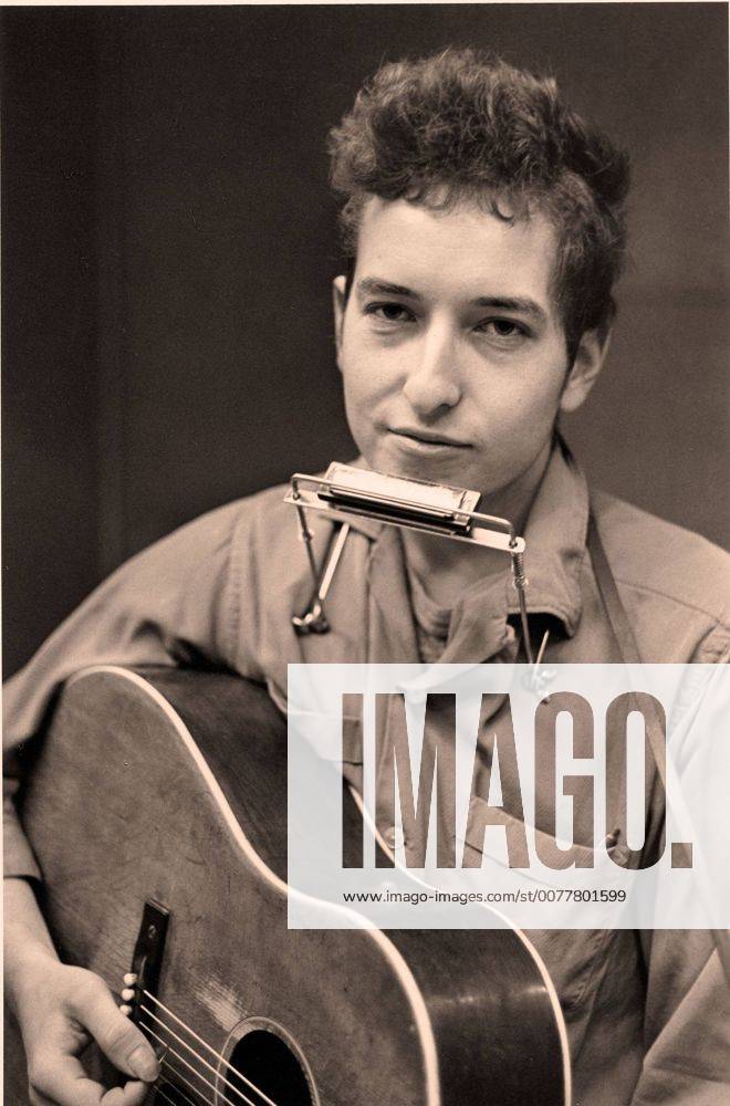 FILE PHOTO - BOB DYLAN, American singer songwriter, poet, folk and rock musician is celebrating his 70th birthday. Dylan sings, plays guitar, harmonica and piano and is considered one of the most influential music makers of the 20th Century. PICTURED - Jan. 19, 2007 - Minneapolis, Minnesota, U.S. - Image of BOB DYLAN with a harmonica around his neck and a guitar in his arms at the Weisman Museum Exhibit Journey 1956-1966 - Bob Dylan . - ZUMAm42_ 20070119_zaf_m42_002