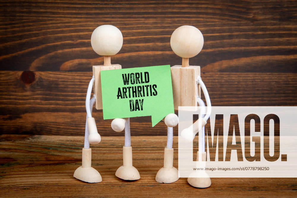 World Arthritis Day 12 October. Green speech bubble with text on wood texture background.