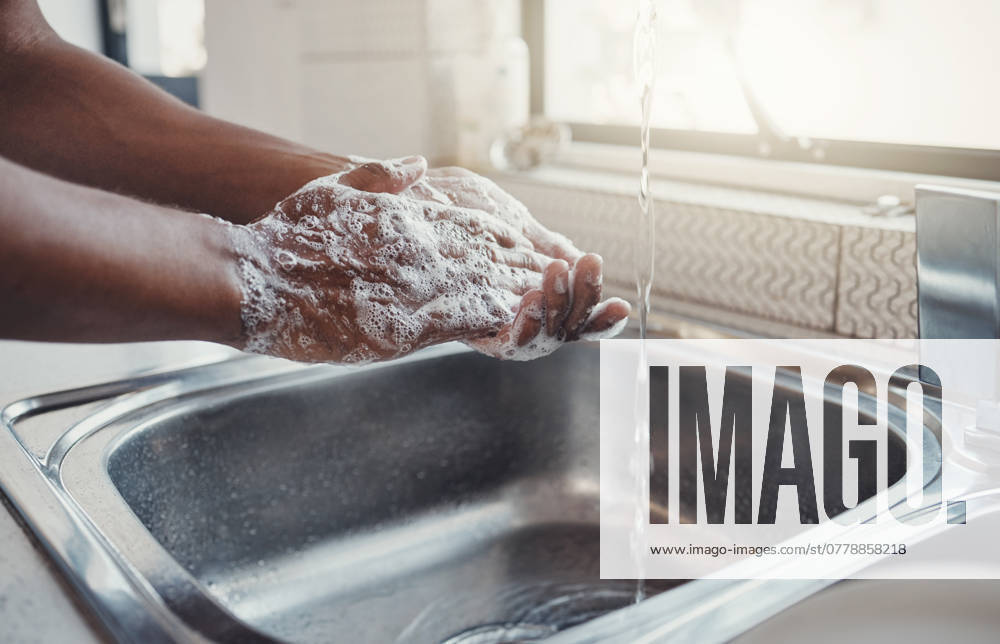 Cleaning, washing hands and kitchen sink with soap for health, home wellness and safety. Cleaner, bacteria prevention and man getting ready for cooking in a household with water doing house chores. model released property released
