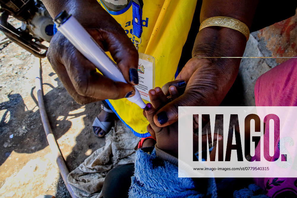 A community health worker seen marking a Childs finger after an oral polio vaccination in Kibera Slums. Polio is a virus that may cause paralysis and is easily preventable through polio vaccine. The virus is easily transmitted through fecal-oral route, contaminated water, Food or body contact with an infected person including respiratory droplets that could lead to a fatal paralysis if no quick medical diagnosis is taken. It mostly affects kids under 5 years of age but also anyone of a different age, who is not vaccinated can contact the diseases. The Kenya Paediatric Association (KPA), a non-profit professional organization including pediatricians, clinicians and local community Health Workers unite they on - ZUMAs197 20241004_aab_s197_041