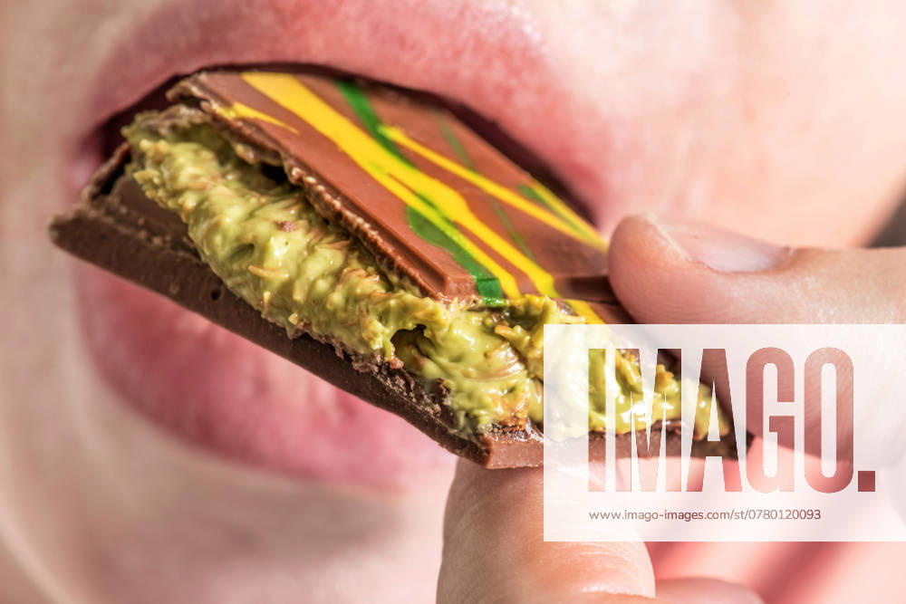 Woman enjoys a piece of Dubai chocolate with kunafa and pistachio cream filling, Hype about Dubai chocolate, Munich, November 2024 Germany,Munich, November 2024, Woman enjoys a piece of Dubai chocolate with kunafa and pistachio cream filling, Orient Delight brand, Made in U A E , United Arab Emirates, which includes Dubai, Hype