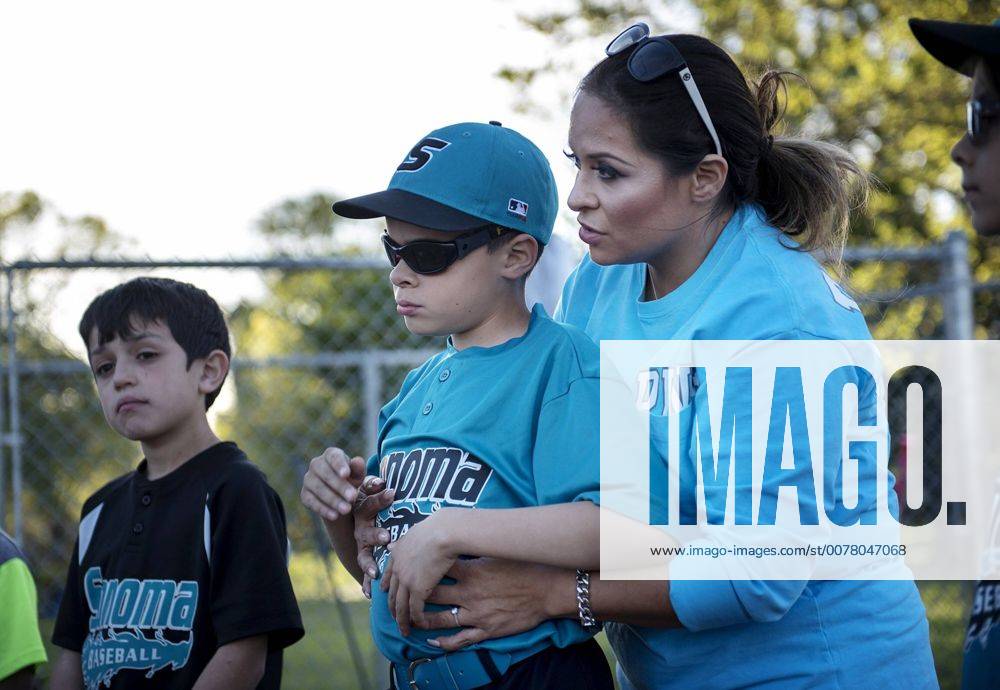 Sacramento, California, U.S. - Wendy Rivera helps her son Jasen Bracy, 9, who is blind, understand the baseball coaching during baseball practice at Sonoma Elementary School in Modesto, Calif., on Wednesday, March, 23, 2016. Jasen lost his sight due to treatments for retinoblastoma, a cancer in the retina of the eye, but despite his lack of vision he plays baseball with the Sonoma Dolphins. Sacramento U.S. - ZUMAm11_ 20160323_zaf_m11_008