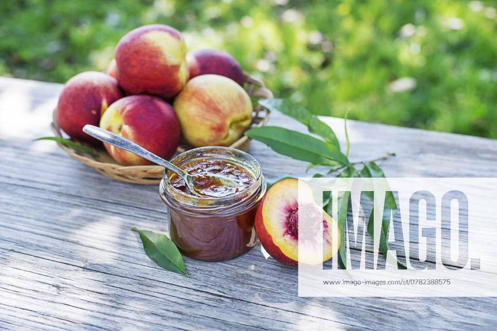 IMAGO Creative, Jahreszeit Sommer, Food, Marmelade kochen Peach jam, Peach jam or marmalade in a glass jar with ripe peaches, outdoors on sunny day, Peach jam or marmalade in a glass jar with ripe peaches, outdoors on sunny day, 22.09.2024,