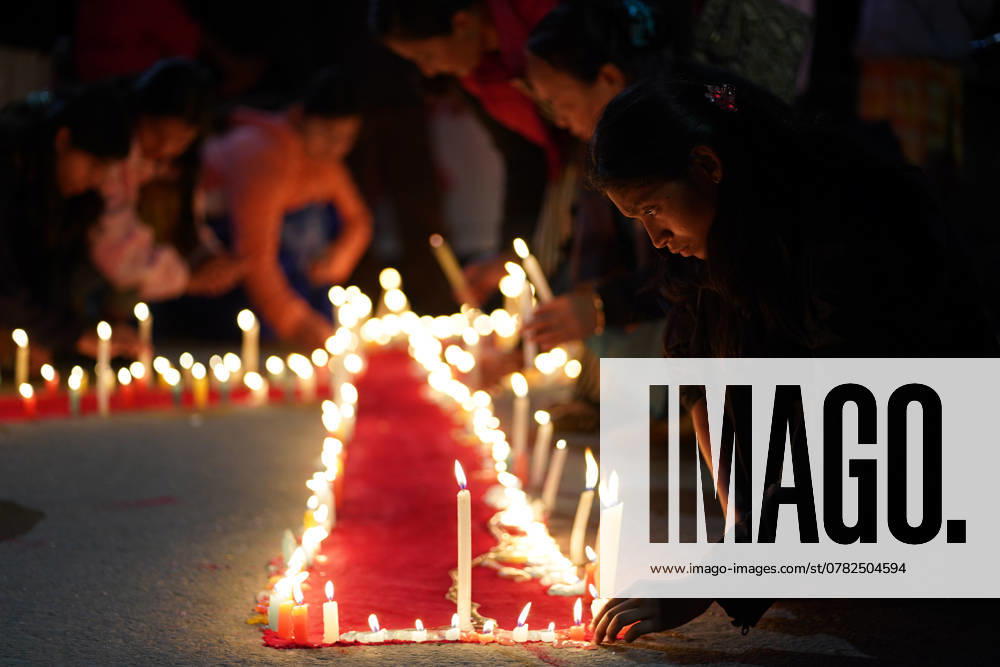 Nepali activistsâ€⠢ light candles along the edge of red ribbon during an awareness event organized on the eve of â€oeWorld AIDS day†in Kathmandu on November, 30, 2024. Kathmandu Nepal - ZUMAd164 20241130_zip_d164_001