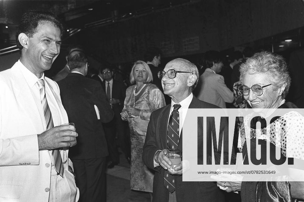 Nobel prize winning economist Professor Milton Friedman (second right) and his wife Rose (right) chat with a guest at a welcome party during his visit to Hong Kong.