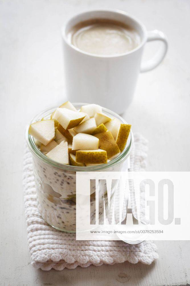 Glass of overnight oats with chia seeds, almond milk and pears EVGF03197