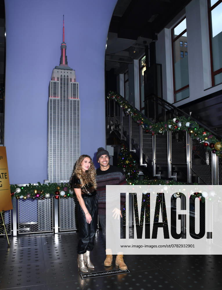 Alexa PenaVega and Carlos PenaVega Light the Empire State Building in Partnership with The Salvation Army in Honor of the Red Kettle Campaign at Empire State Building in New York. December 2, 2024. New York United States - ZUMAp281 20241202_zea_p281_024