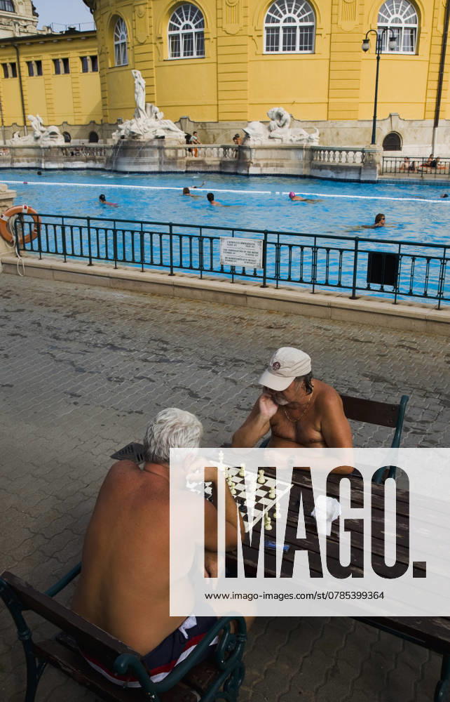 Hungary, Budapest, Pest, Bathers playing chess in summer at Szechenyi thermal baths, largest in Europe. Budapest Hungary