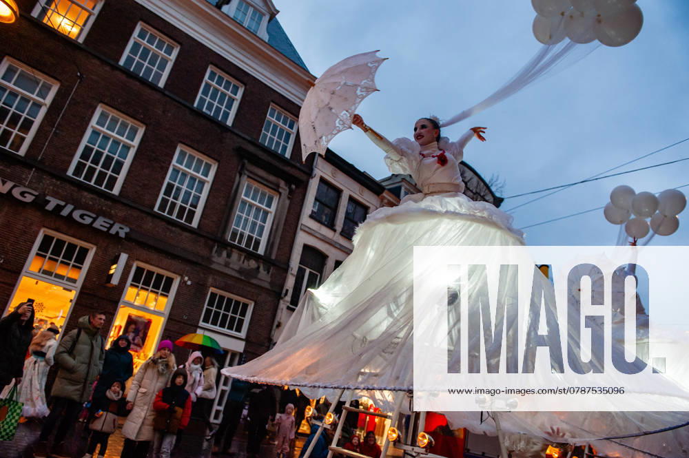Families are seen looking at the dancers passing by. The Christmas season started in Nijmegen with a beautiful winter parade made up of a group of acrobatic artists performing on special bikes and young people dancing with lights. Once arrived at the Grote Market, alderman John Brom lights up the Christmas tree. The Winter Wonder Parade is part of the Nijmegen Winter Weeks, which counts with several activities for children. Nijmegen Netherlands - ZUMAs197 20241221_aaa_s197_249