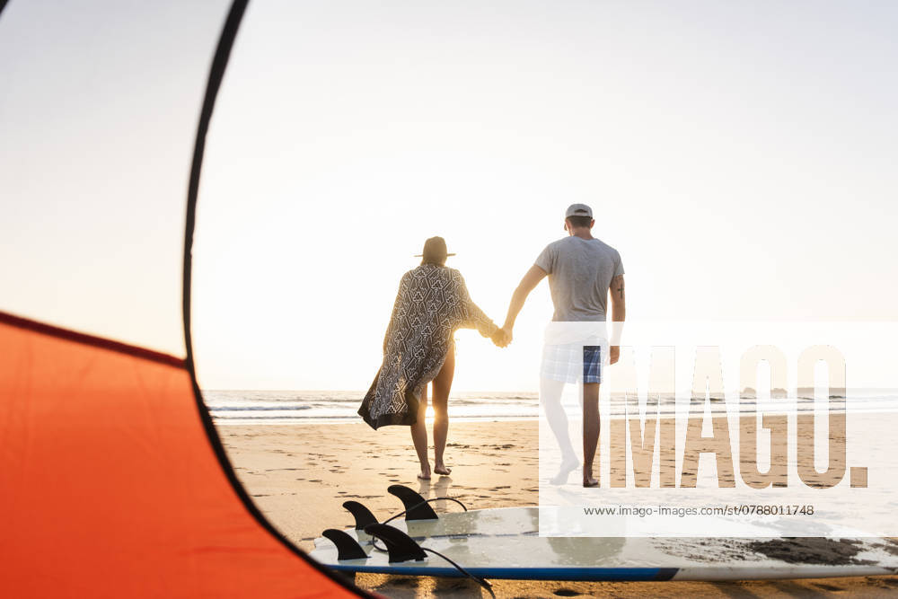 Romantic couple camping on the beach, doing a beach stroll at sunset model released, Symbolfoto, UUF15147