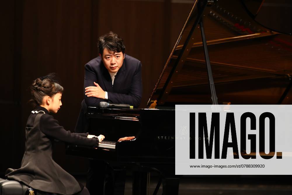 Pianist Lang Lang guides the child to play the piano during his solo concert at Nanchang Poly Grand Theatre on December 24, 2024 in Nanchang, Jiangxi Province of China.