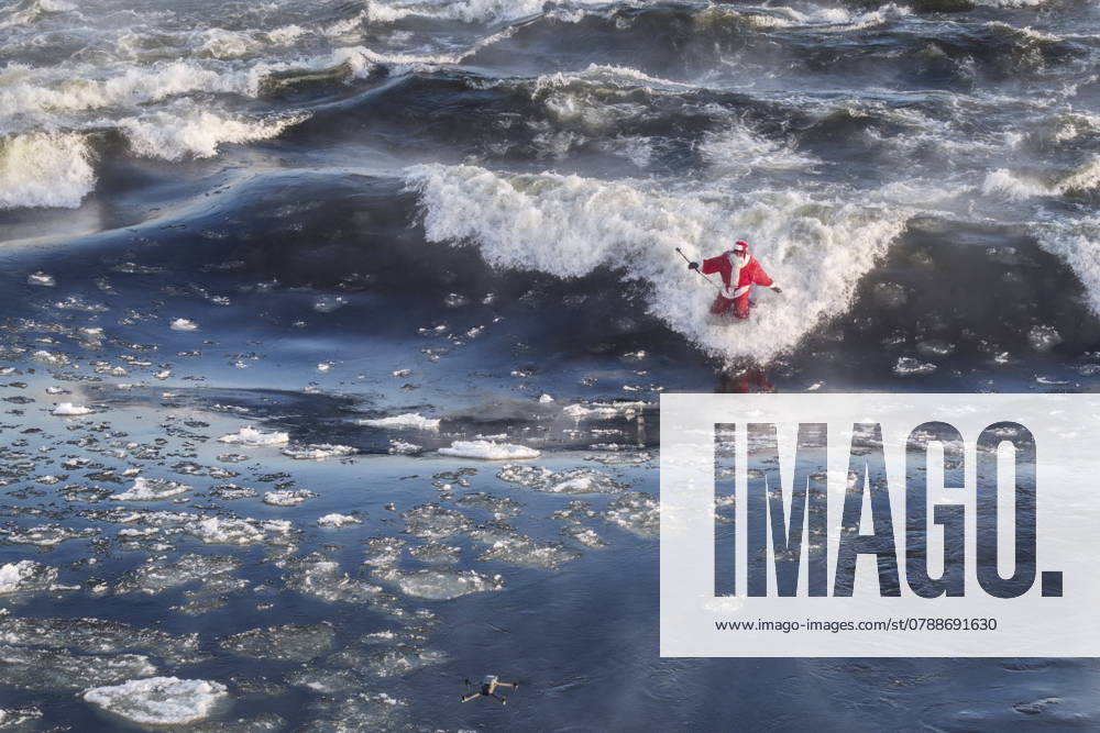 Carlos Hebert Plante, who boogie boards daily, dressed as Santa Claus to hit the water amid an air temperature of -14 degrees Celsius on Christmas Day, in Montreal, Wednesday, Dec. 25, 2024. The standing wave on the St-Lawrence River is close to downtown Montreal and itöÄÃ s a popular spot for surfers. Montreal Canada - ZUMAc35_ 20241225_zaf_c35_022