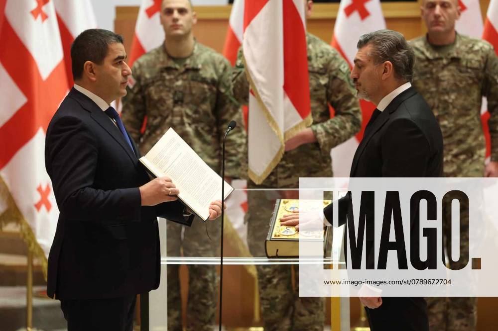 (241229) -- TBILISI, Dec. 29, 2024 -- Mikheil Kavelashvili (R) takes an oath during his swearing-in ceremony held at the Parliament building in Tbilisi, Georgia, Dec. 29, 2024. Kavelashvili was sworn in as Georgia s sixth president in a ceremony held at the Parliament building on Sunday, Interpressnews reported. Among the people attending the inauguration were key members of the government and Kavelashvili s family, the news agency reported. ( Handout via Xinhua) GEORGIA-TBILISI-NEW PRESIDENT-SWEAR IN GeorgianxParliament