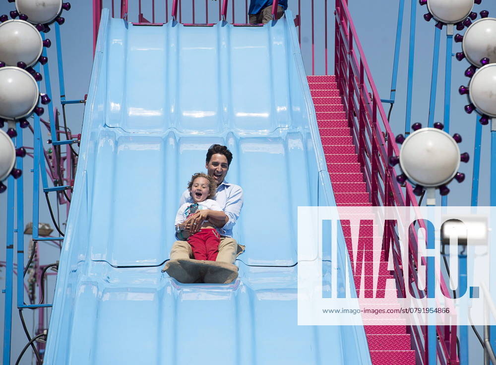 Prime Minister Justin Trudeau and his four-year-old son Hadrien head down the Super Slide as they attend the Old Home Week fair in Charlottetown on Monday, Aug. 13, 2018. Charlottetown Canada - ZUMAc35_ 20180813_zaf_c35_009