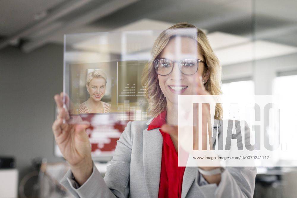 Businesswoman communicating via futuristic portable device model released Symbolfoto property released PESF00587
