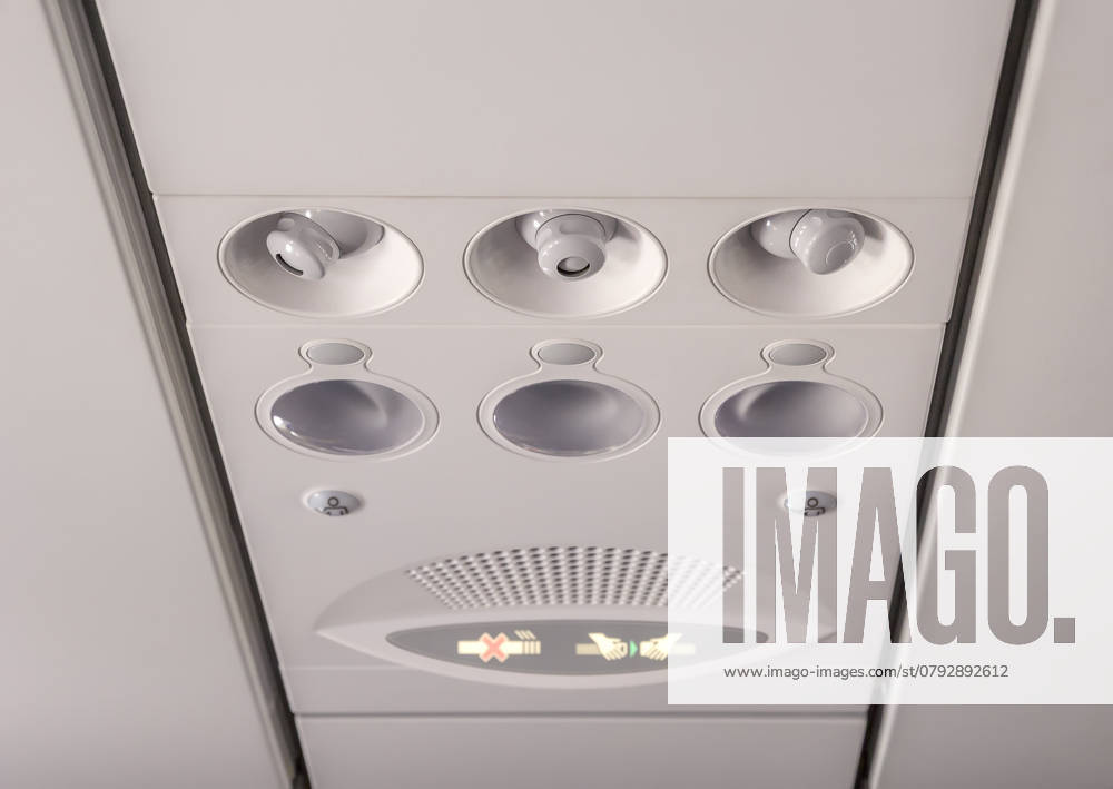 Adjustable lights and air conditioners overhead seat controls of a commercial aircraft in an airplane with no-smoking and seat belt on signs , 46760644.jpg, nobody, part, transport, inside, air, travel, transportation, panel, fly, flight, console, airplane, conditioner, sign, cabin, aircraft, plane, light, overhead, control, interior, aviation, conditioning, board, button, lamp, cool, seat, jet, ventilation, closeup, vent, smoke, ceiling, seating, safety, warning, no, plastic, aeroplane, airline, knob, detail, round, symbol, commuter, security, passenger, airliner, background RECORD DATE NOT STATED