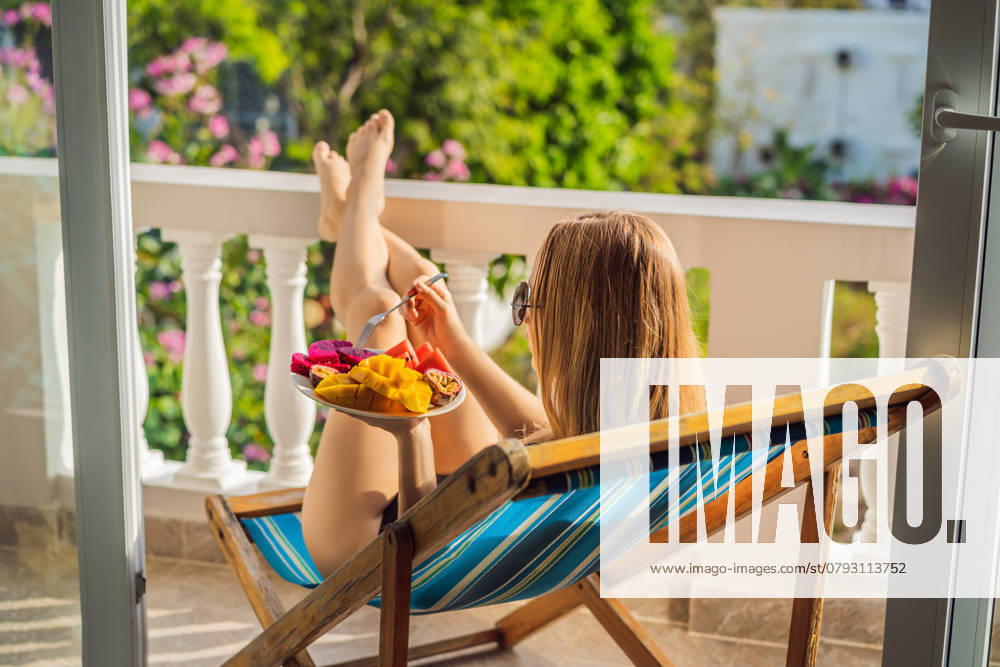 Young woman resting on a balcony with a plate of fruit. life-work balance, relaxation healthy quality living lifestyle in summer holiday vacation of freelancer woman take it easy resting in resort hotel balcony having peace of mind., model released, , 46905614.jpg, woman, vacation, resort, balcony, fruit, lifestyle, hotel, holiday, summer, healthy, work, quality, peace, mind, living, life, easy, take, street, breakfast, luxury, balance, positive, relaxation, resting, rest, travel, recreation, spa, girl, sun, pleasure, sexy, brunette, lying, flowers, view, relaxing, fresh, journey, care, slim, food, comfort, portrait, beautiful, one, tropics, tourism, person RECORD DATE NOT STATED