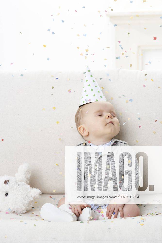 Portrait of baby boy with eyes closed wearing paper hat model released Symbolfoto FSF00926