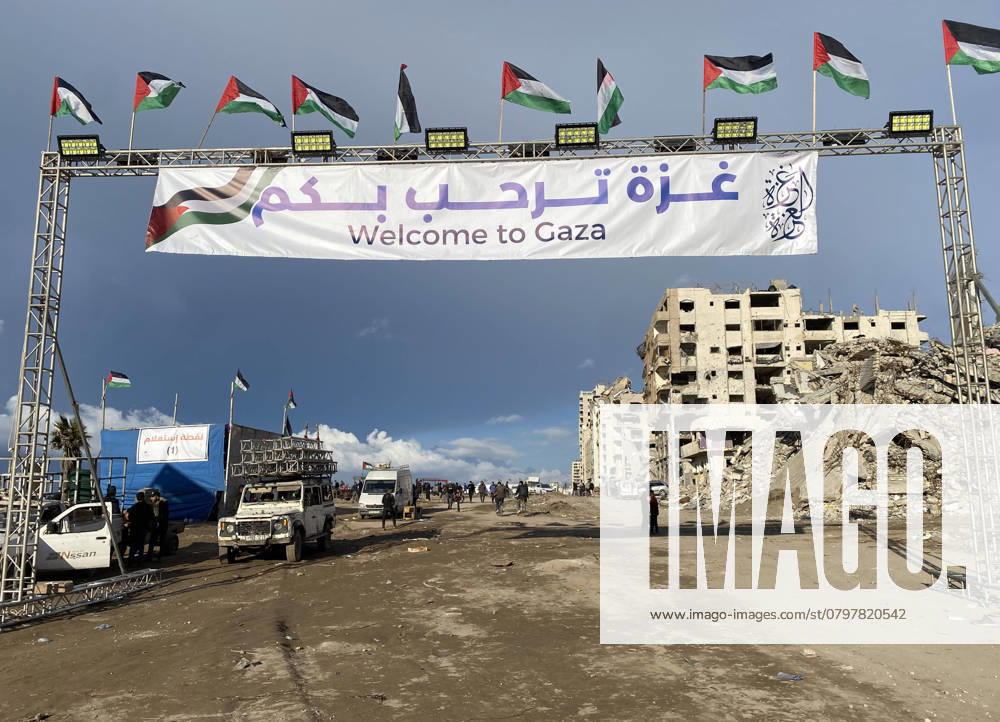 People gather by a banner welcoming people near the rubble of a collapsed building along Gaza s People gather by a banner welcoming people near the rubble of a collapsed building along Gaza s coastal al-Rashid Street for people to cross from the Israeli-blocked Netzarim corridor from the southern Gaza Strip into Gaza City on January 26, 2025. Israel said on January 25 it would block the return of displaced Palestinians to their homes in northern Gaza until Arbel Yehud, one of the hostages taken captive during the October 7, 2023 attacks, is released. Hamas sources said that Yehud was alive and in good health , and would be released as part of the third swap set for next Saturday , on February 1. Photo by Hadi Daoud apaimages Gaza city