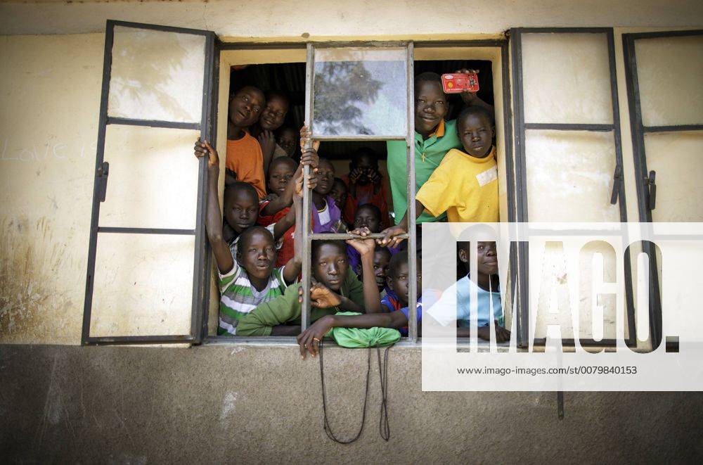 Schueler schauen aus einem offenen Fenster einer Schule im Rhino Refugee Camp Settlement im Norden Ugandas. Hier werden Kinder von Einheimischen und Fluechtlingen gemeinsam unterrichtet. In dem Gebiet leben rund 90.000 Fluechtlinge aus dem Suedsudan, Uganda, 09.08.2017. KEIN MODEL RELEASE vorhanden, NO MODEL RELEASE available, NO MODEL RELEASE. Rhino Uganda