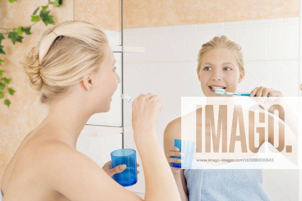 Young girl in the bathroom brushing her teeth in the morning A5