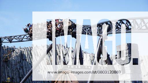 Young people have fun on a ride on the Taron rollercoaster in the Klugheim themed area at the Phantasialand theme park 24198036