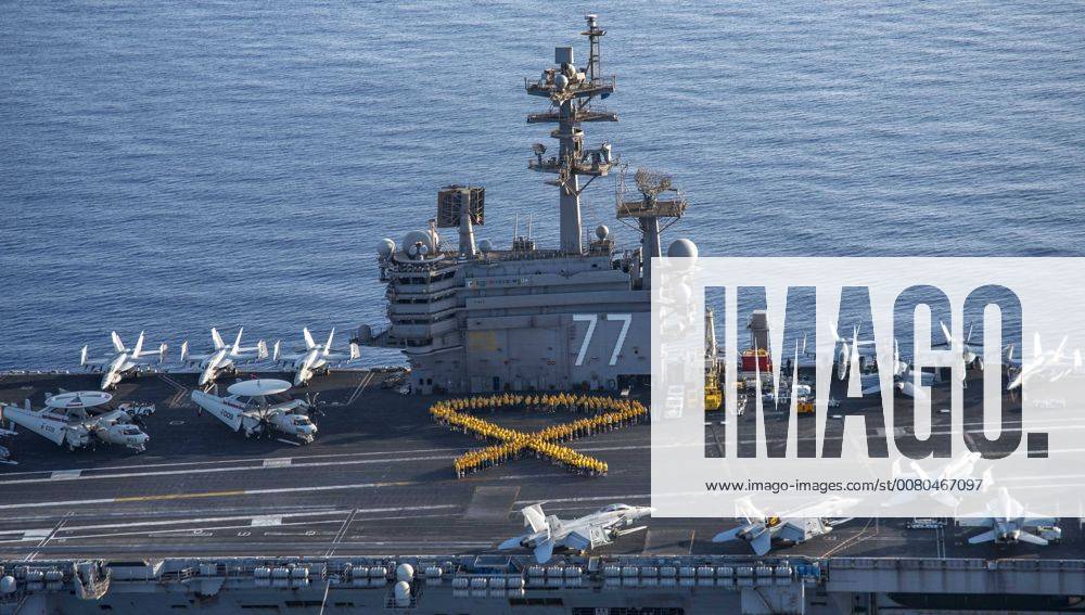 At sea - U.S. sailors form a yellow human ribbon in support of Suicide Prevention and Awareness Month on the flight deck aboard the U.S. Navy Nimitz-class aircraft carrier USS George H.W. Bush July 22, 2017 in the Mediterranean Sea. At sea - ZUMAp138 20170722_zaa_p138_014