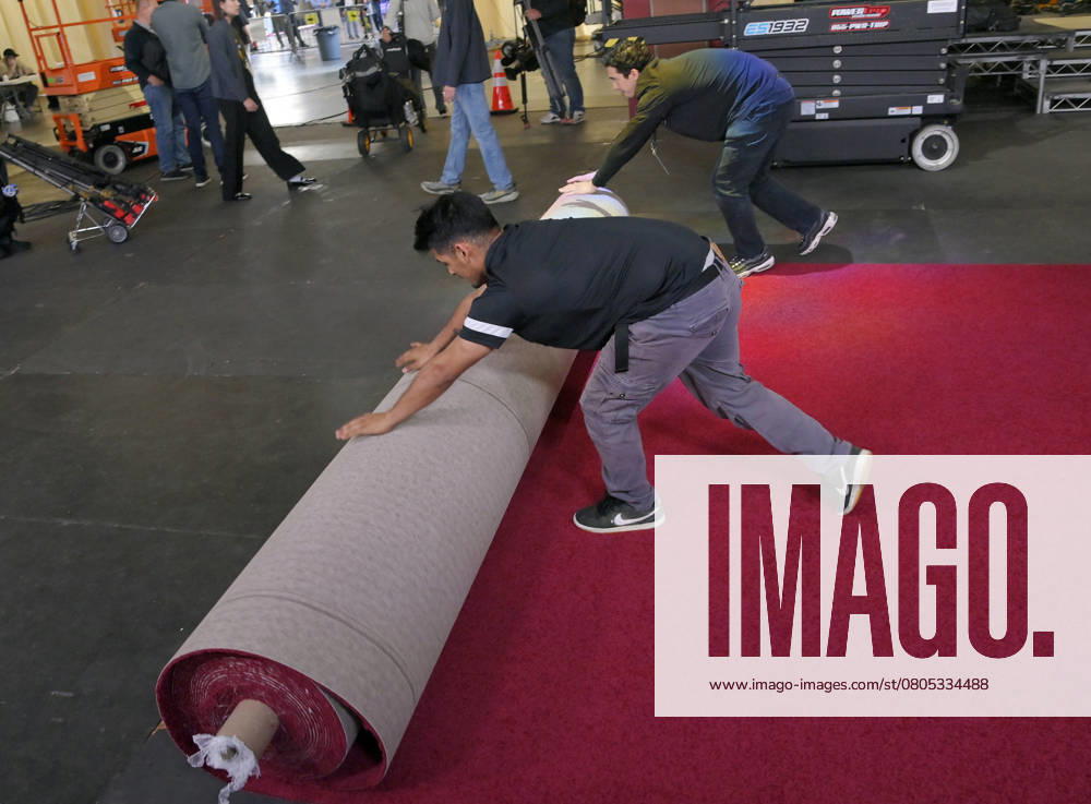 Crew members roll out the red carpet in preparation for the 97th Academy Awards in the Hollywood section of Los Angeles, California on Wednesday, February 26, 2025. Oscar winners will be announced during an ABC live telecast on March 2. LAP2025022601 JIMxRUYMEN