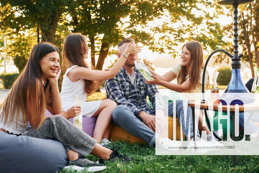 Drinking game. Group of young people have a party in the park at summer daytime., model released, , 51356710.jpg, group, people, hookah, smoking, culture, party, drink, cocktails, sitting, relaxing, resting, alcohol, beverage, armchair, bags, fun, together, outdoors, outside, summer, park, green, grass, caucasian, white, european, ethnicity, casual, clothes, wear, joy, cheerful, wellness, wellbeing, nice, positive, emotions, friends, weekend, leisure, free, time, sunlight, sunshine, beautiful, conversation, talking, communicating, socializing, young RECORD DATE NOT STATED