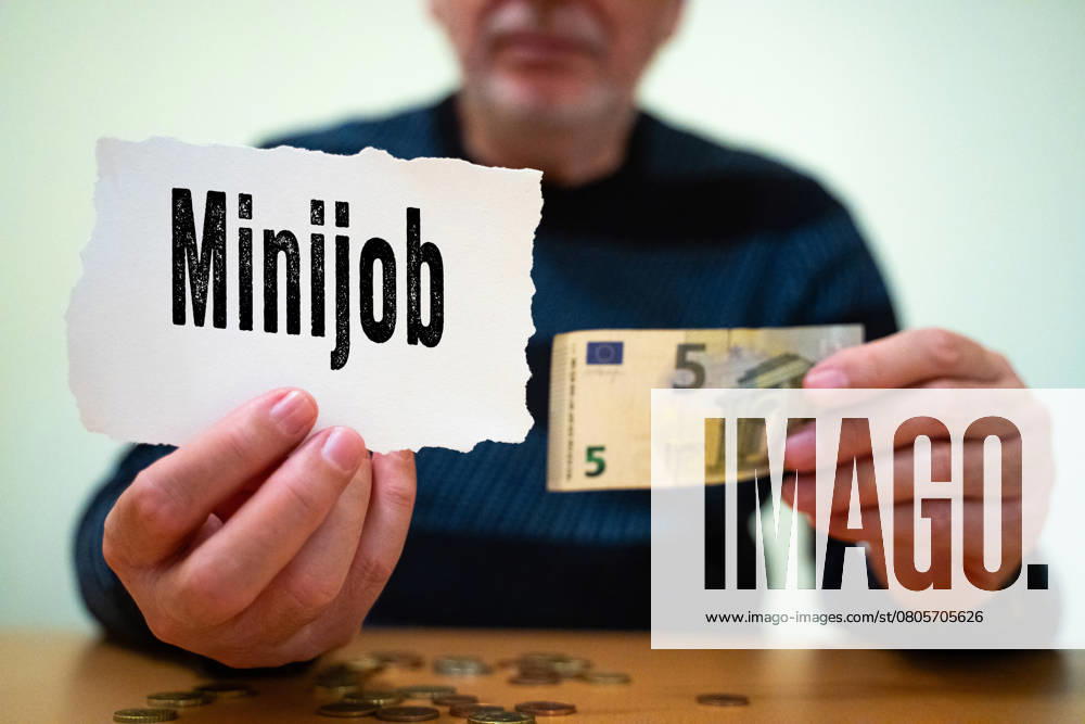 PHOTOMONTAGE. A man holds a sign saying Minijob and a 5-euro bill in his hand. Mini-jobs play an important role for low-income earners and pensioners who need to supplement their income.