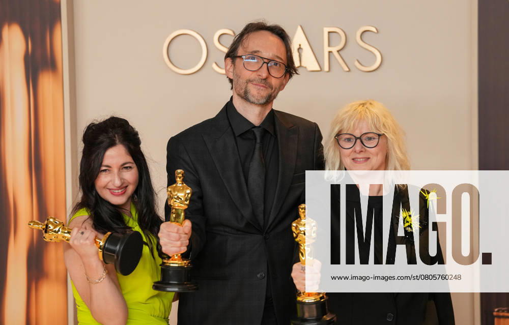 Marilyne Scarselli, Pierre-Olivier Persin, and Stéphanie Guillon (L-R) celebrate backstage after winning the Oscar for makeup and hairstyling for The Substance during the 97th Academy Awards in the Hollywood section of Los Angeles on Sunday, March 2, 2025. LAP20250302120 PATxBENIC