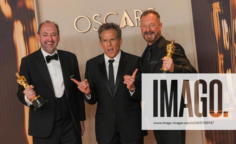 Nathan Crowley and Lee Sandales of Wicked celebrate backstage with Academy Award presenter Ben Stiller (C) after winning the Oscar for best production design during the 97th Academy Awards in the Hollywood section of Los Angeles on Sunday, March 2, 2025. LAP20250302126 PATxBENIC