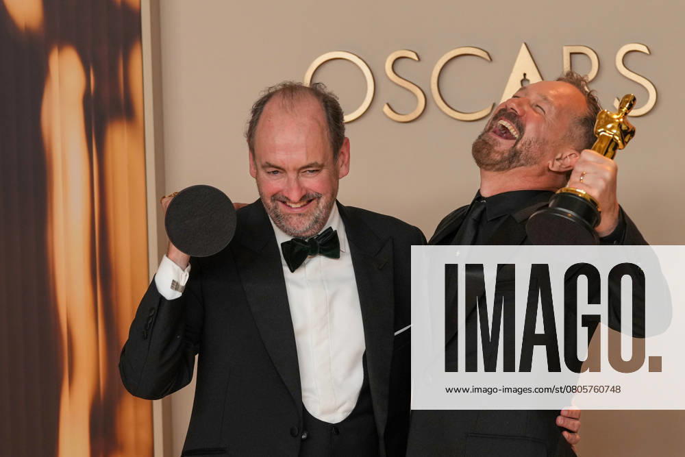 Nathan Crowley and Lee Sandales of Wicked celebrate backstage after winning the Oscar for best production design during the 97th Academy Awards in the Hollywood section of Los Angeles on Sunday, March 2, 2025. LAP20250302127 PATxBENIC